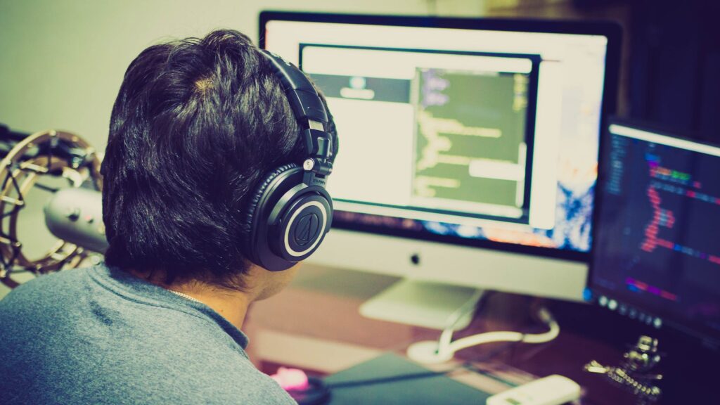 selective focus photography of man facing computer